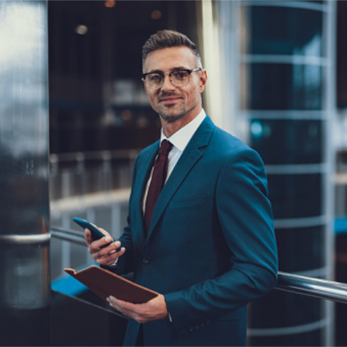 a man holding a book and a pen