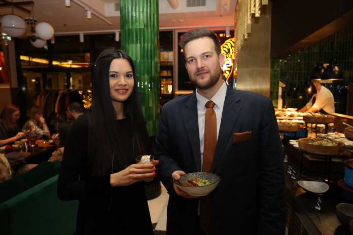 a man and woman holding drinks