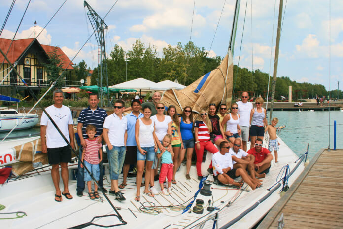 a group of people posing for a photo on a dock